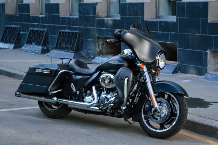 a black motorcycle parked on the side of the road