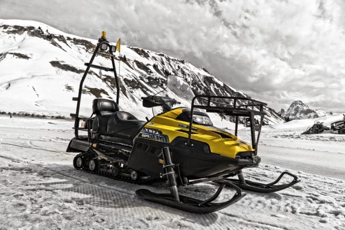 a snowmobile parked on the side of a mountain