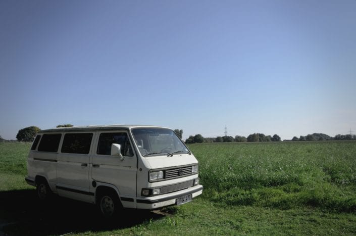 a van parked in the middle of a field