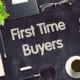 first time buyer written on the table with office equipment around it