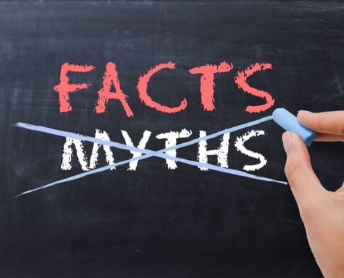 myths on a board crossed out with facts written in red above it