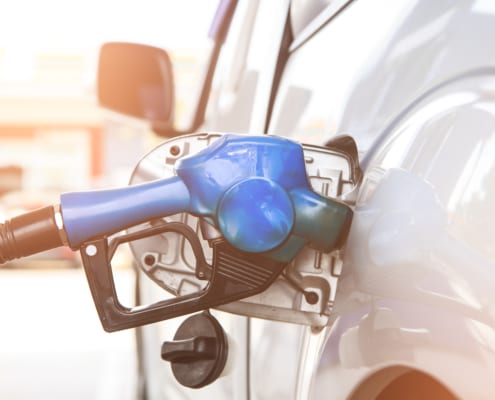 a gas nozzle in a car tank filling gas