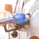 a gas nozzle in a car tank filling gas