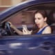 woman using her phone while zooming down the road