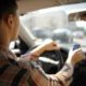 a person checking his phone while driving a car