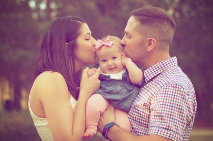 Individual Health Insurance Parents holding a baby and smiling at each other