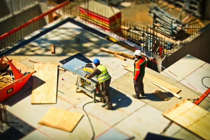 Construction workers on job site wearing safety gear