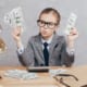 a kid dressed up as an accountant counting cash