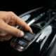 a finger pulling an electronic hand break