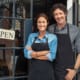 a business owner couple standing outside their business