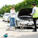 Insurance adjuster assessing car and bicycle accident damage on roadside
