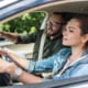a woman taking her driving test with an instructor sitting next to her with a clipboard