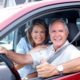 an old couple sitting in their car