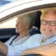 a elderly couple sitting in their car