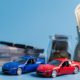 Car insurance savings concept with model cars and cash in glass jars