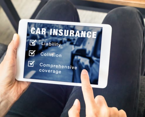 a person signing up for car insurance on an ipad