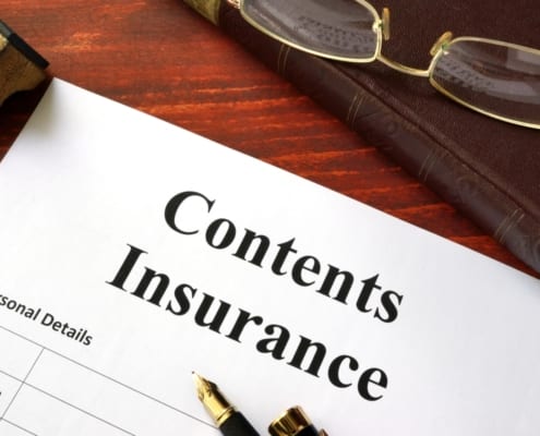 a content insurance form on a table with a pen on it
