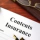 a content insurance form on a table with a pen on it