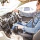 a disabled person sitting in the driving seat of his car