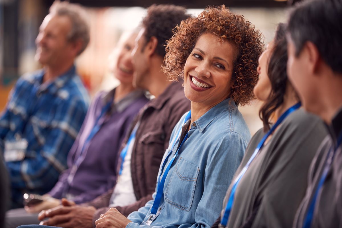 Diverse professionals networking and smiling at business conference event