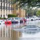 car in a parking lot submerged in water after a storm/flood