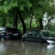 car submerged in water on a street due to a flood