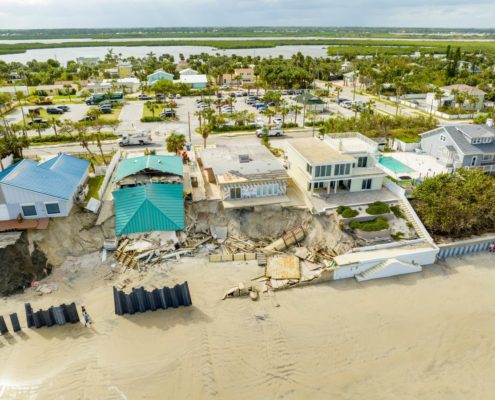 Coastal homes damaged by beach erosion and storm surge along shoreline