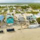 Coastal homes damaged by beach erosion and storm surge along shoreline