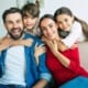 children hugging their parents sitting on the couch