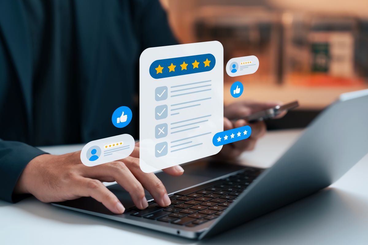 Customer leaving five-star online review on laptop and smartphone