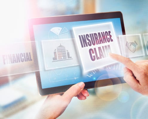 person tapping an insurance claim graphic on an ipad