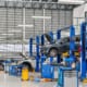 a car mechanic shop with cars being worked on