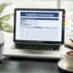 general liability insurance opened on a laptop with a coffee on a table