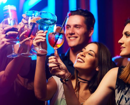 friends in a club cheering their drinks