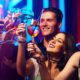 friends in a club cheering their drinks