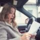 a woman looking shocked while looking at a piece of paper in her hand