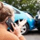 a woman on her phone with an accident infront of her