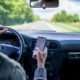 a man driving his car down the road while texting
