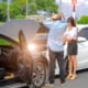 an accident with the owners of the cars standing outside and looking