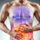 a man with his hands on his stomach with red showing uncomfortableness in his stomach
