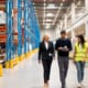1 guy and 2 ladies walking around in a facility