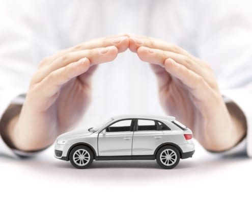 a pair of hands making a roof over a car toy model