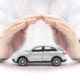 a pair of hands making a roof over a car toy model