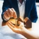 a real estate agent handing keys to a person who just signed his new house agreement