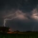 a stormy night with a cloud throwing lightening to the ground
