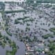 Aerial view of widespread residential flooding with homes surrounded by water
