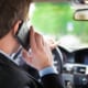 a man talking on his phone while driving a car