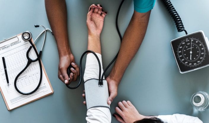 Short Term Health Insurance Healthcare worker measuring a patient's blood pressure
