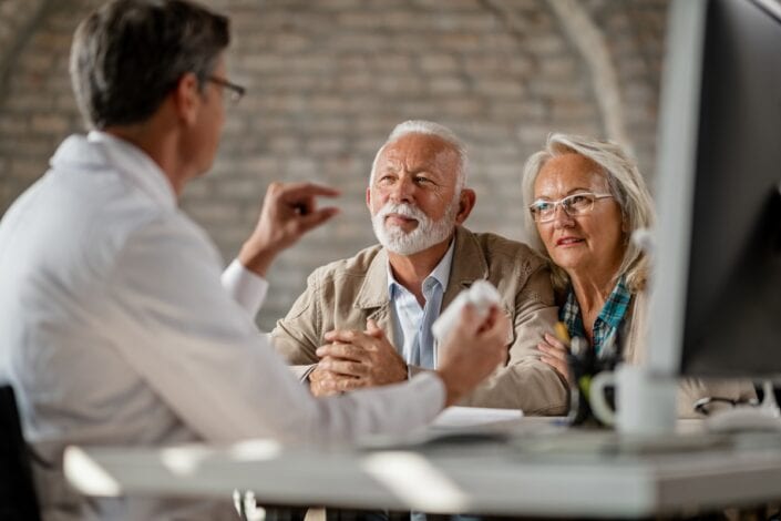 an old couple talking to a doctor