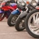 row of motorcycle parked in a parking lot